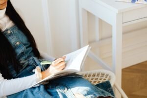 Person journaling to identify and name their feelings using the feelings wheel