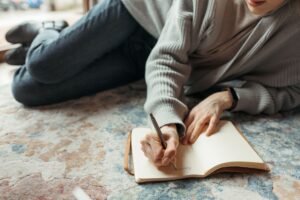 Person journaling to reframe and challenge negative thoughts