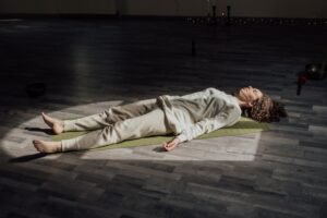 Person lying down in deep relaxation during a yoga nidra meditation