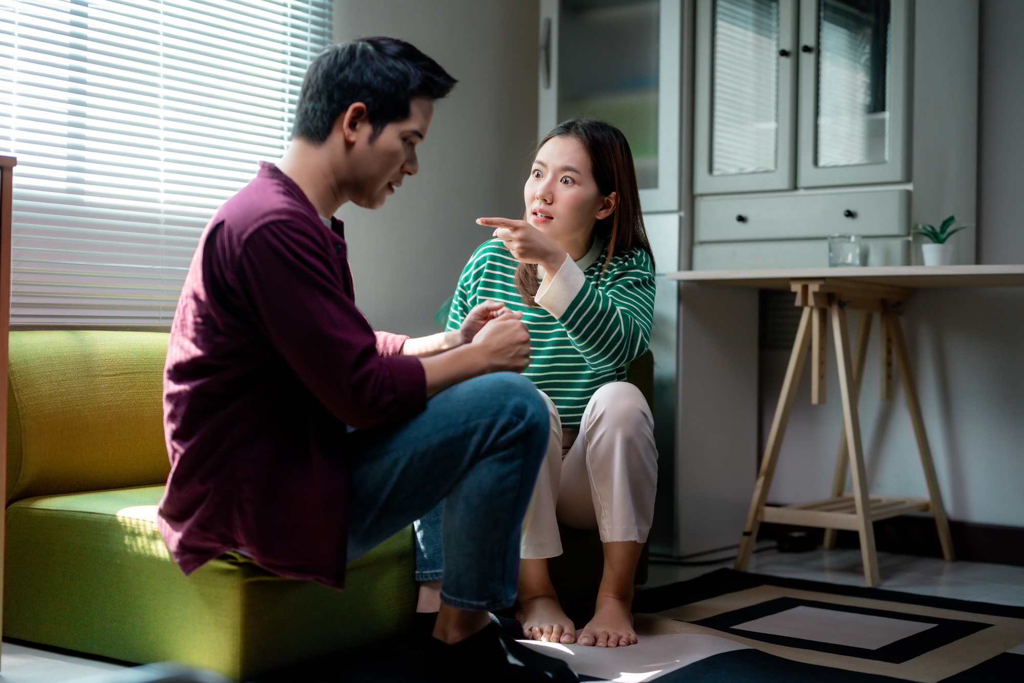 Young asian couple arguing at home, having relationship problems