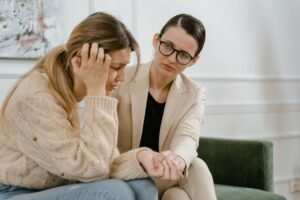 A therapist offering supportive care to an emotional client, illustrating emotion focused therapy techniques
