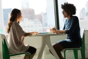 Two people in a supportive conversation illustrating what it means to hold space for someone
