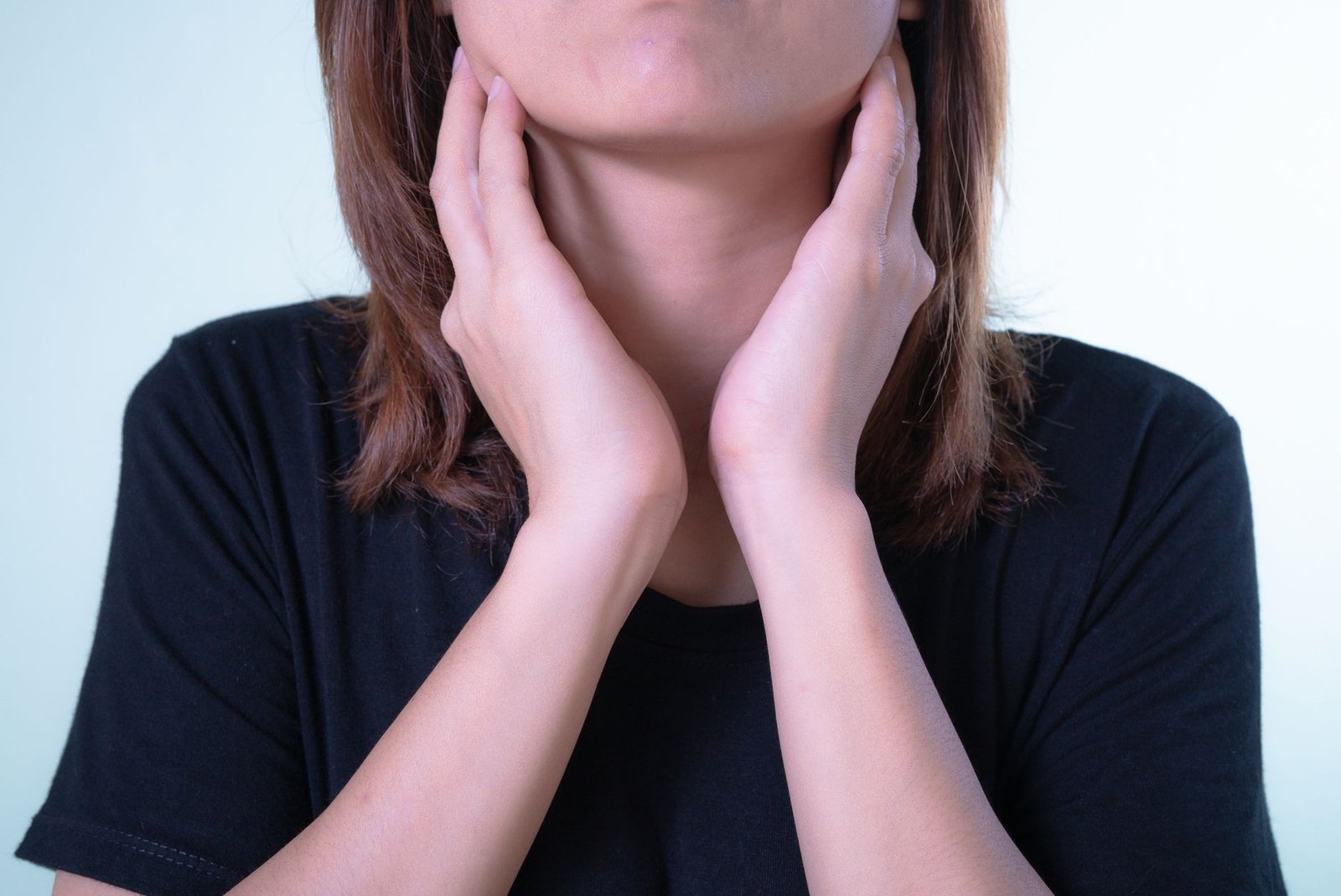 Woman with hands on her face, struggling to let herself be more vulnerable in everyday life