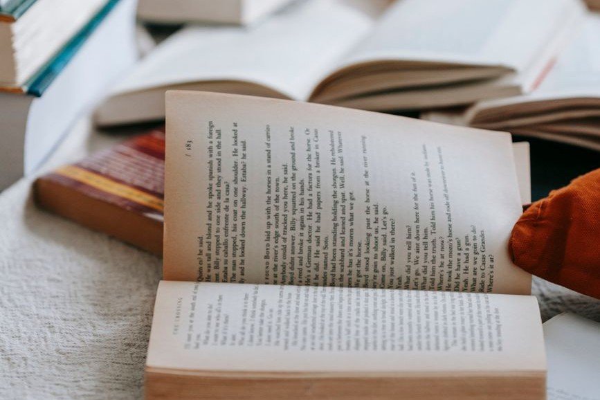 A cozy stack of open breathwork books for learning breathing techniques and practice