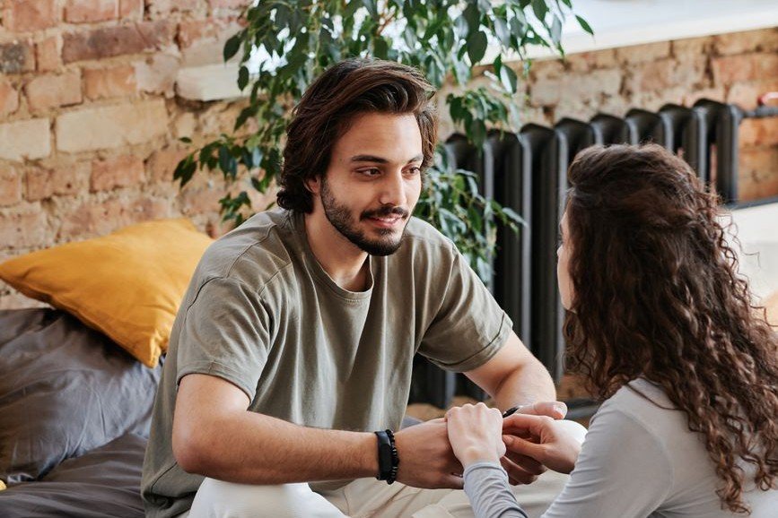 Couple sitting close in an honest, trusting conversation while navigating vulnerability together