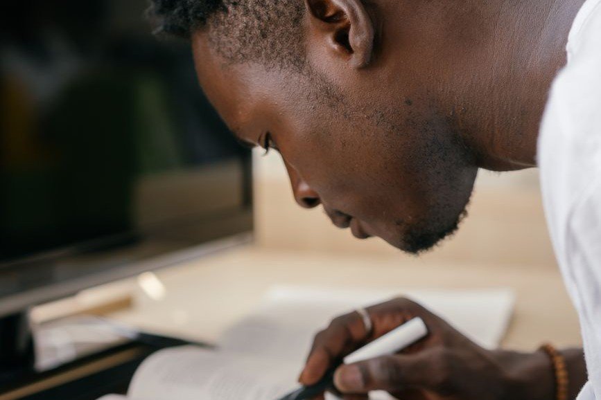 Person focused and studying at a desk, illustrating the learning curve behind the Dunning-Kruger effect