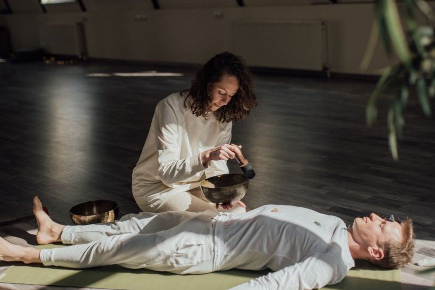 Person lying down in deep relaxation during a holotropic breathwork session