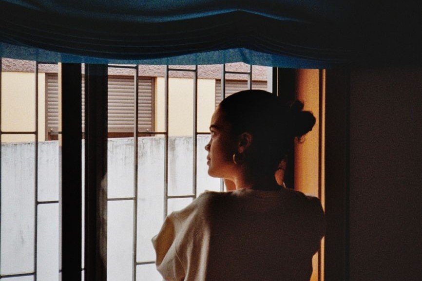 Woman calmly looking out at her surroundings, illustrating neuroception and the body’s sense of safety